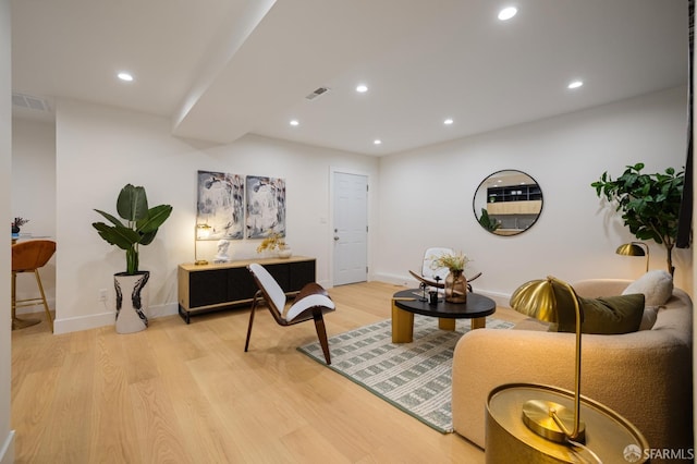living room featuring light wood-type flooring, recessed lighting, and baseboards