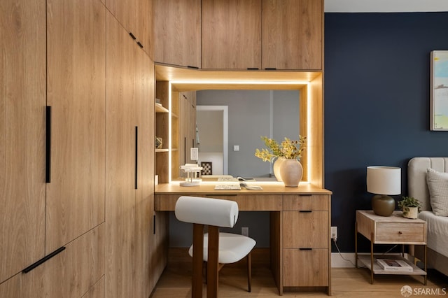 home office with light wood finished floors