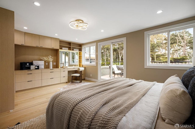 bedroom featuring access to exterior, light wood-type flooring, and recessed lighting