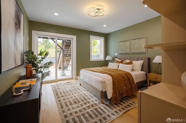 bedroom with access to outside, light wood-type flooring, and recessed lighting