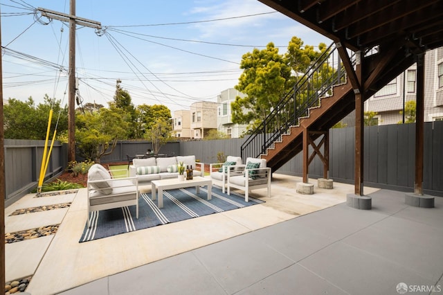 view of patio / terrace featuring outdoor lounge area, stairway, and a fenced backyard