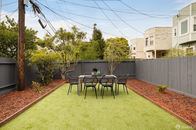 view of yard featuring outdoor dining area