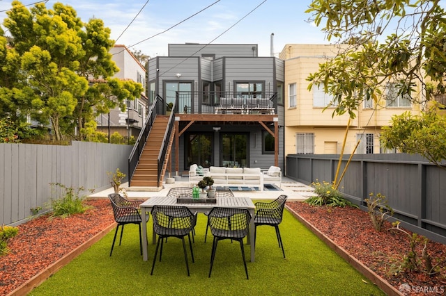 back of house with outdoor lounge area, stairs, a patio area, and a deck
