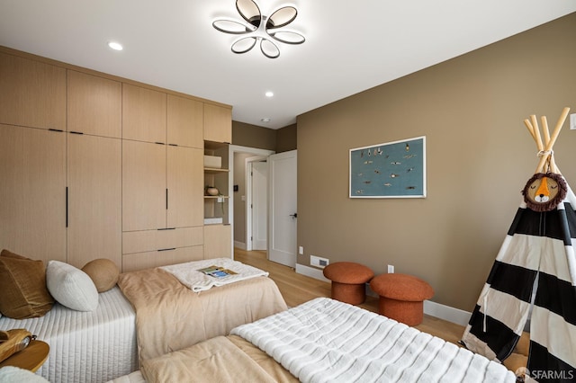 bedroom with light wood-type flooring, baseboards, and recessed lighting