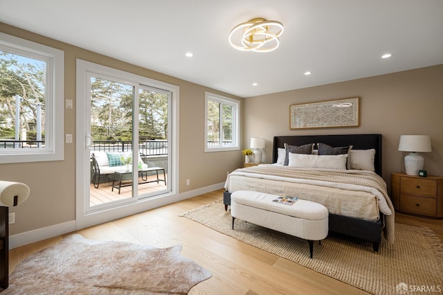 bedroom featuring access to exterior, light wood-style flooring, baseboards, and recessed lighting