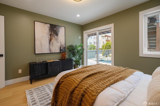 bedroom with access to exterior, light wood-type flooring, recessed lighting, and baseboards