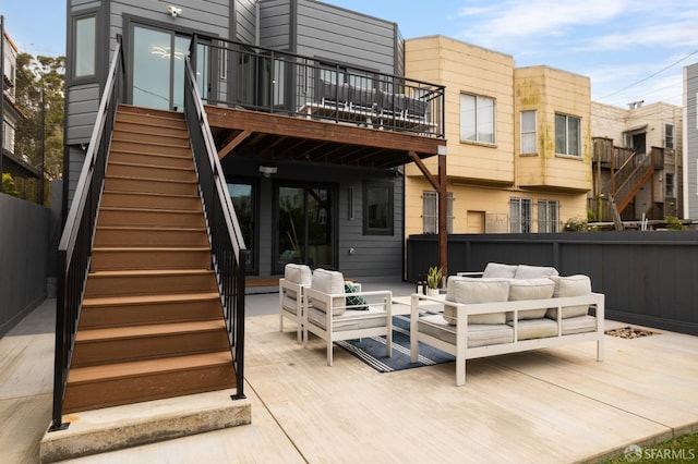 back of property featuring stairway, an outdoor living space, a deck, and fence