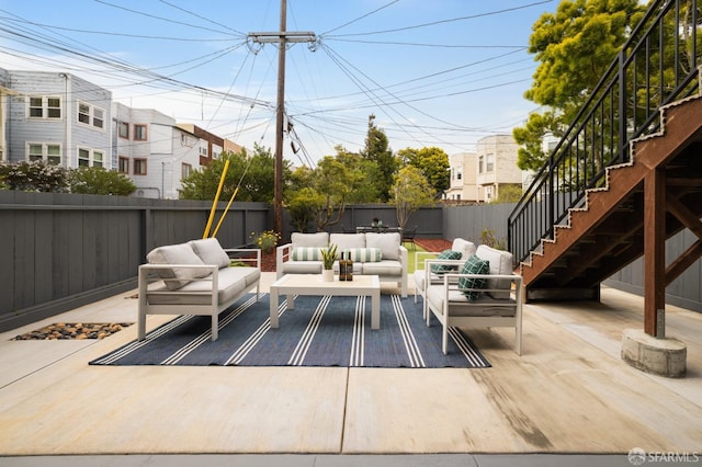 view of patio / terrace with an outdoor living space, a fenced backyard, stairway, and a residential view