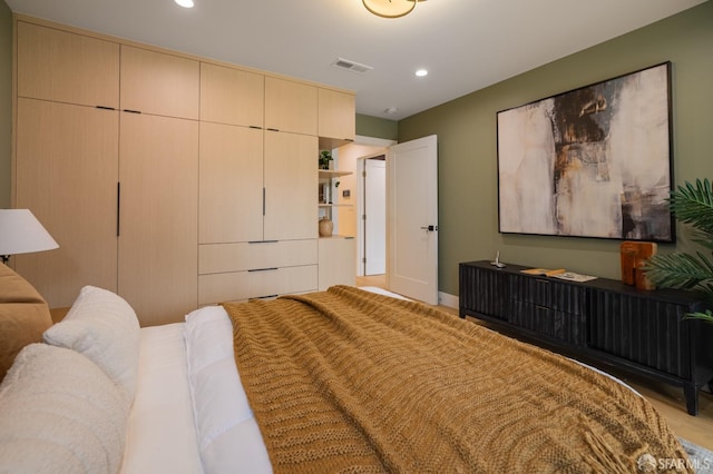 bedroom with recessed lighting, light wood-style floors, and baseboards