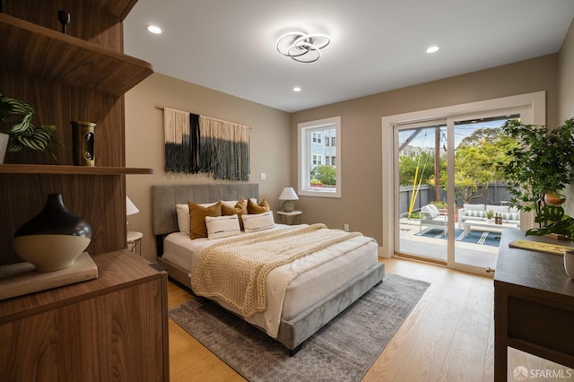 bedroom featuring access to outside, light wood-type flooring, and recessed lighting