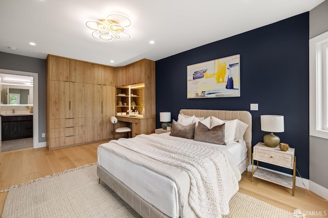 bedroom featuring light wood-type flooring, recessed lighting, and baseboards