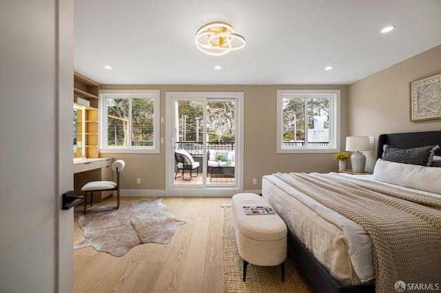 bedroom with access to outside, multiple windows, wood finished floors, recessed lighting, and baseboards