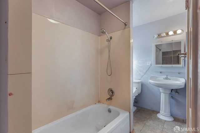 bathroom with toilet, a sink, tile patterned flooring, and washtub / shower combination