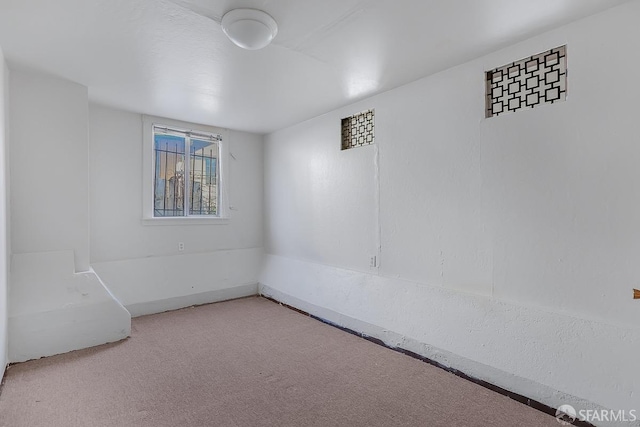 unfurnished room with light carpet