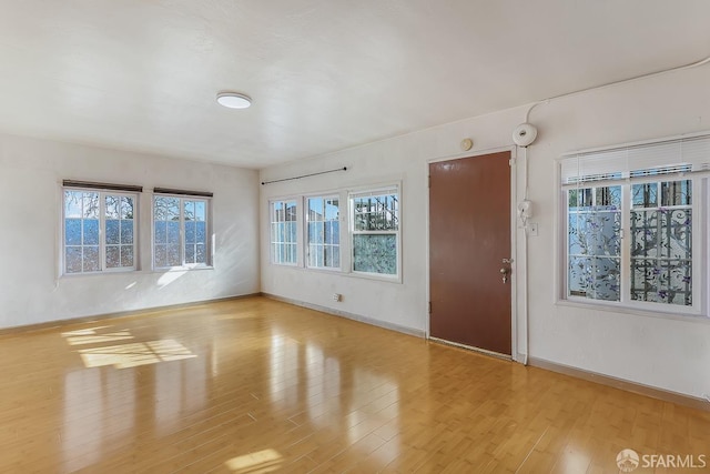 interior space featuring wood finished floors and baseboards