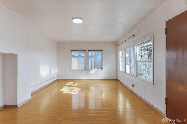 unfurnished room featuring light wood-style floors and baseboards