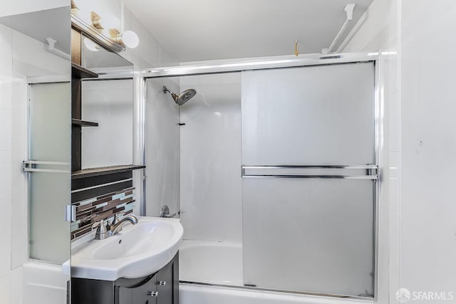 bathroom featuring shower / bath combination with glass door and vanity