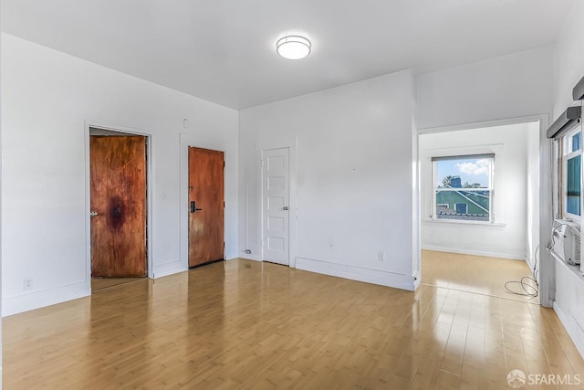 unfurnished bedroom featuring light wood-type flooring and baseboards