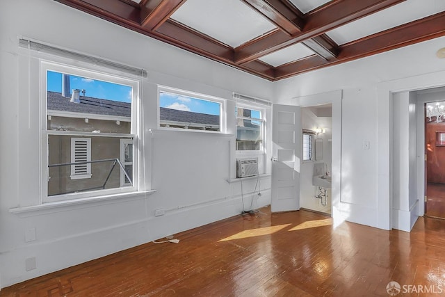 unfurnished room featuring hardwood / wood-style flooring, cooling unit, coffered ceiling, and beamed ceiling