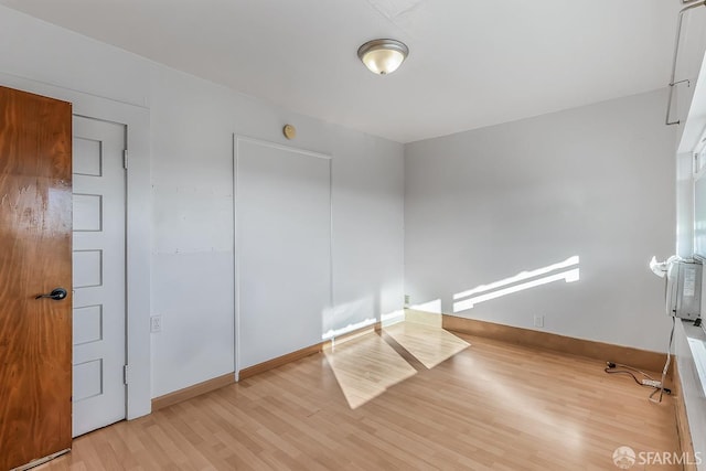 bedroom featuring wood finished floors and baseboards