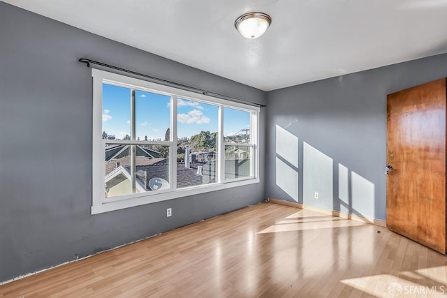 spare room with wood finished floors