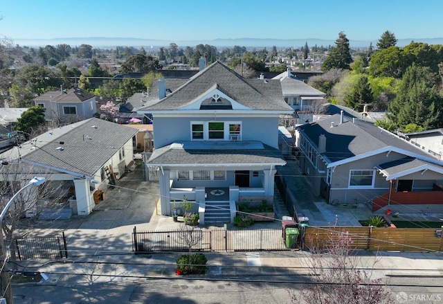 view of front of house with a fenced front yard, a shingled roof, a gate, driveway, and stairs