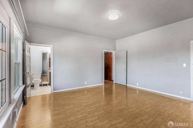 unfurnished bedroom featuring baseboards and light wood finished floors