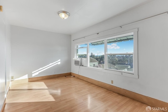 empty room featuring baseboards and wood finished floors