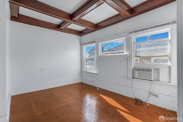 empty room with beam ceiling, wood finished floors, cooling unit, coffered ceiling, and baseboards