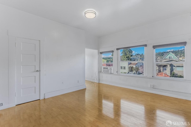 spare room with light wood finished floors and baseboards