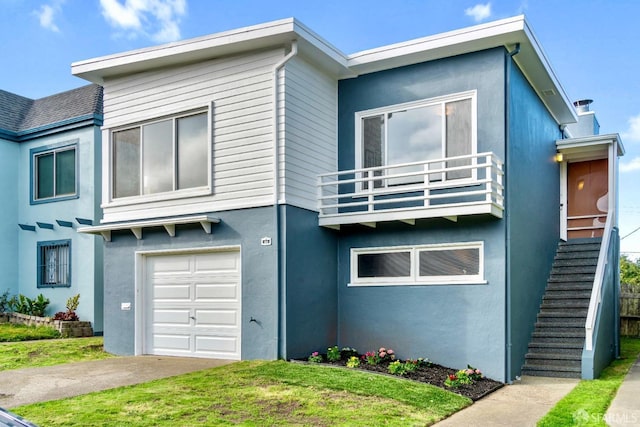 view of front facade with a garage, a balcony, stairs, and stucco siding