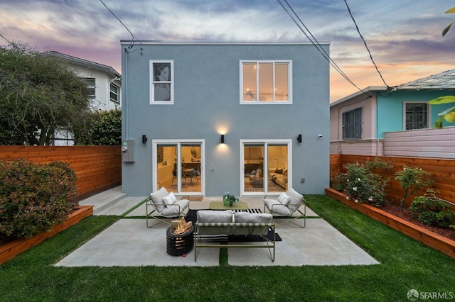 26 Southwood Dr, San Francisco, CA 94112 - back of house at dusk with stucco siding, a patio, and an outdoor living space