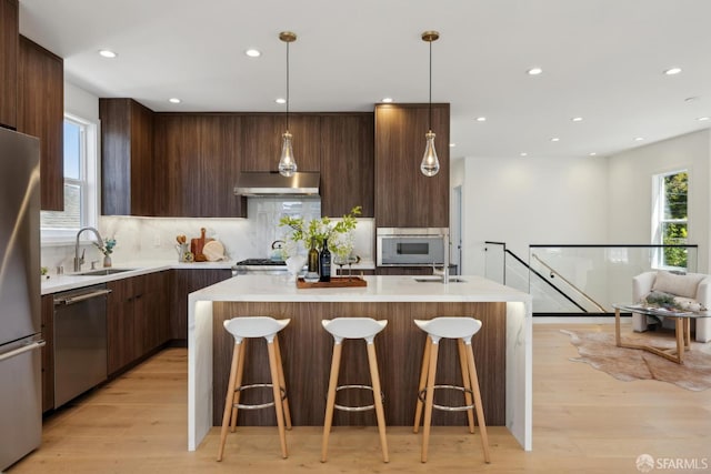 26 Southwood Dr, San Francisco, CA 94112 - kitchen featuring stainless steel appliances, modern cabinets, range hood, a sink, and light countertops
