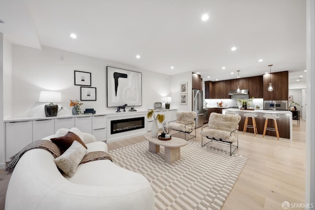 26 Southwood Dr, San Francisco, CA 94112 - living room with light wood-style floors, recessed lighting, and a glass covered fireplace