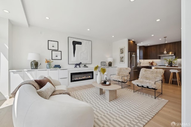 26 Southwood Dr, San Francisco, CA 94112 - living area with light wood finished floors, recessed lighting, and a glass covered fireplace