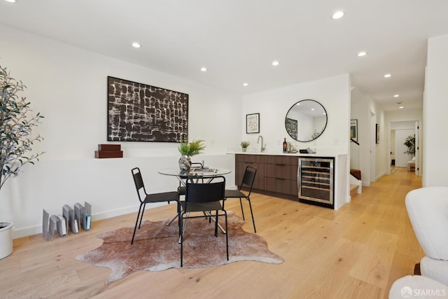 26 Southwood Dr, San Francisco, CA 94112 - dining space featuring beverage cooler, light wood-style flooring, recessed lighting, bar with sink, and baseboards