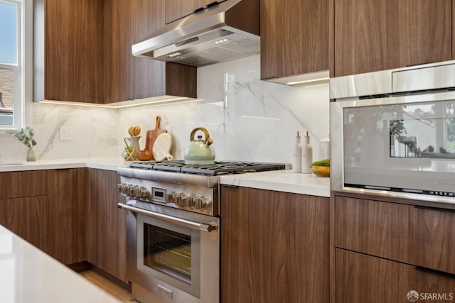 26 Southwood Dr, San Francisco, CA 94112 - kitchen with ventilation hood, stainless steel stove, modern cabinets, decorative backsplash, and light countertops