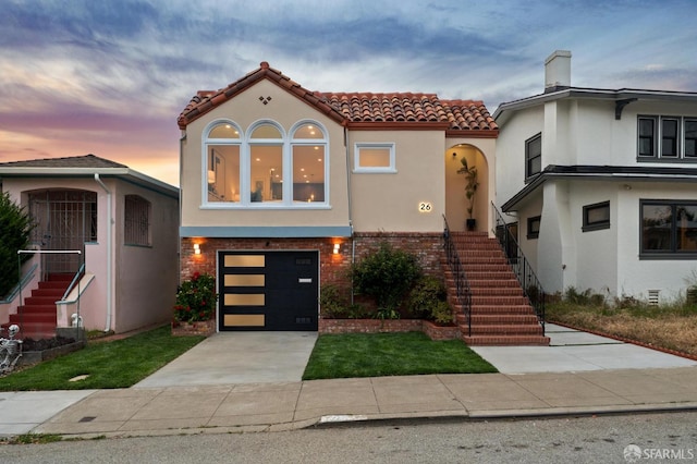 26 Southwood Dr, San Francisco, CA 94112 - mediterranean / spanish-style house featuring a tiled roof, stairway, concrete driveway, stucco siding, and an attached garage
