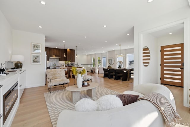 26 Southwood Dr, San Francisco, CA 94112 - living room with recessed lighting, light wood-type flooring, and a glass covered fireplace
