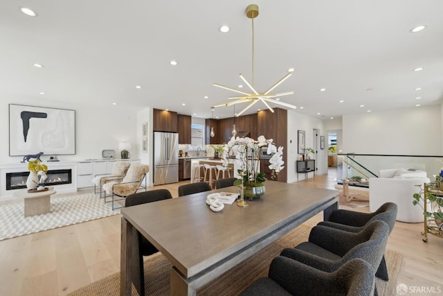 26 Southwood Dr, San Francisco, CA 94112 - dining room featuring a glass covered fireplace, light wood-type flooring, healthy amount of natural light, and recessed lighting