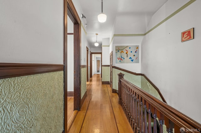 3340 24th St, San Francisco, CA 94110 - corridor with light wood-style floors and a wainscoted wall