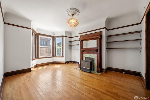 3340 24th St, San Francisco, CA 94110 - unfurnished living room featuring light wood-style floors, a fireplace with flush hearth, and baseboards