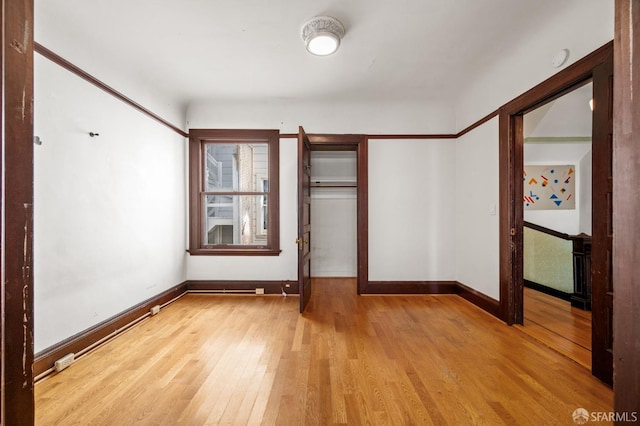 3340 24th St, San Francisco, CA 94110 - unfurnished bedroom featuring wood finished floors, baseboards, and a closet