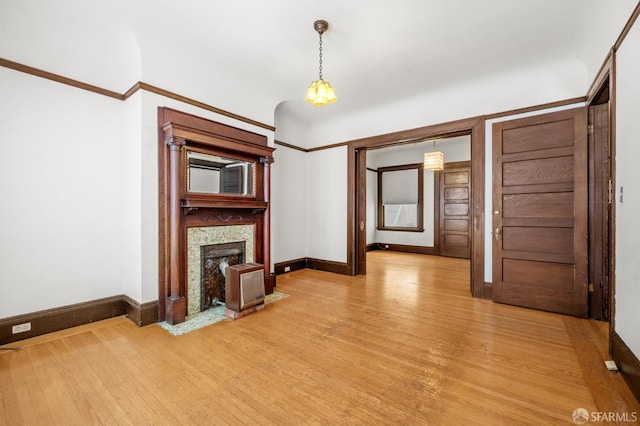 3340 24th St, San Francisco, CA 94110 - unfurnished living room with light wood-type flooring, baseboards, and a fireplace