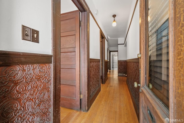 3340 24th St, San Francisco, CA 94110 - hallway featuring light wood finished floors and a wainscoted wall