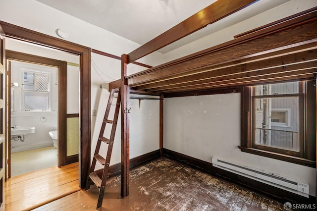 3340 24th St, San Francisco, CA 94110 - basement featuring a baseboard heating unit and stairs