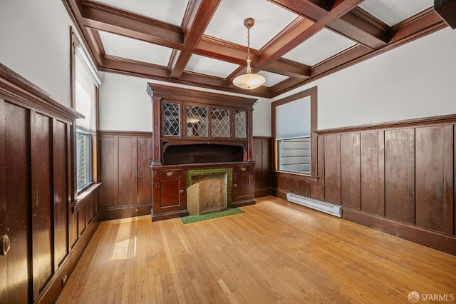 3340 24th St, San Francisco, CA 94110 - unfurnished living room featuring a baseboard heating unit, beamed ceiling, light wood-style floors, a wainscoted wall, and coffered ceiling