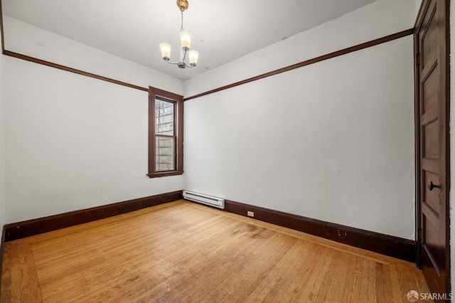3340 24th St, San Francisco, CA 94110 - unfurnished room featuring a chandelier, wood finished floors, a baseboard heating unit, and baseboards