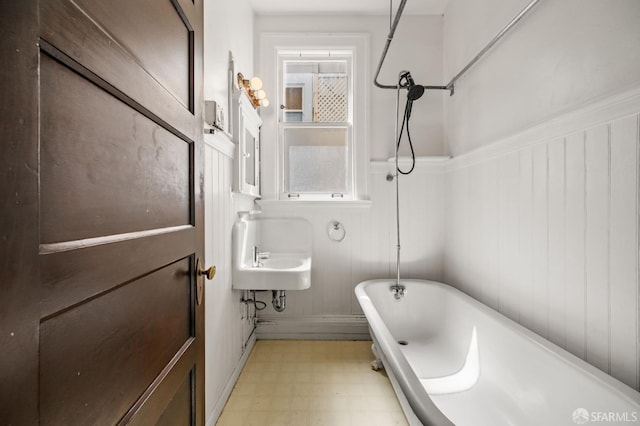 3340 24th St, San Francisco, CA 94110 - bathroom featuring tile patterned floors, a freestanding bath, a wainscoted wall, and a shower