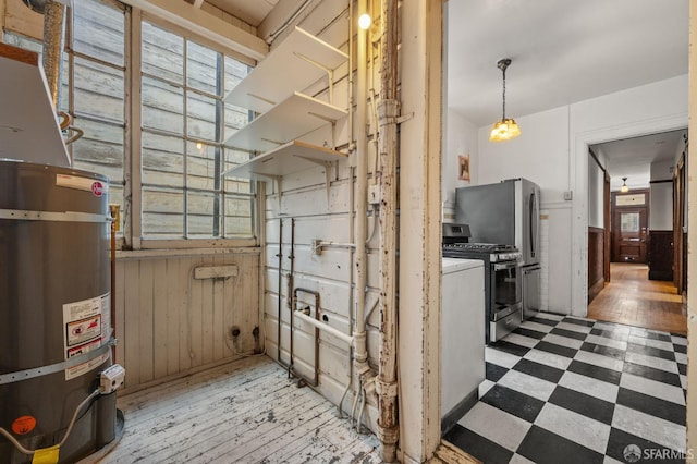 3340 24th St, San Francisco, CA 94110 - kitchen with gas stove, tile patterned floors, secured water heater, a wainscoted wall, and wooden walls